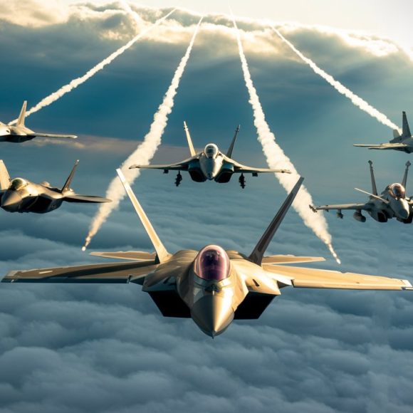 Air superiority fighter jets flying above the clouds with visible contrails, showcasing modern military aviation power under a dramatic sky.